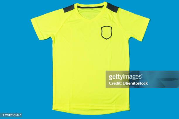 yellow soccer team t-shirt on blue background. concept of sport, soccer ball, uniform, world cup and team. - sports jersey stock-fotos und bilder