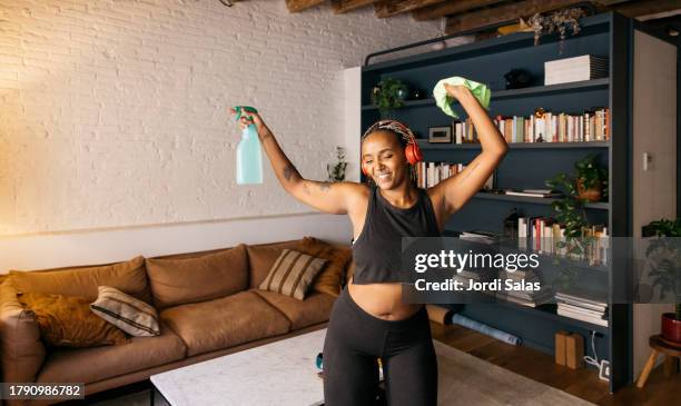 young woman doing house cleaning - female dancer stock pictures, royalty-free photos & images