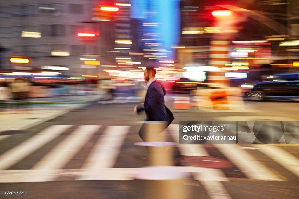 Bearded businessman on the move in NYC, blurred motion