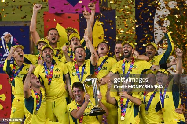 Australia's players celebrate with the trophy after winning the 2023 ICC Men's Cricket World Cup one-day international final match against India at...