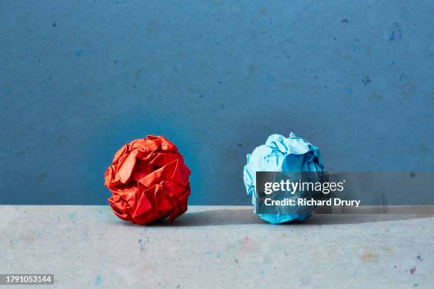 two crumpled paper balls - side by side comparison stock pictures, royalty-free photos & images