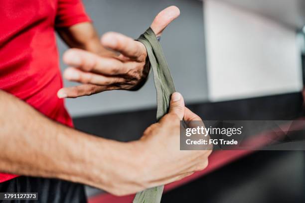 close-up of a man putting elastic bandage on hands at boxe gym - ace bandage stock pictures, royalty-free photos & images