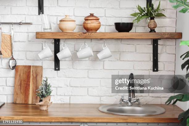 white kitchen interior in scandinavian style with kitchenware and green plants - counter surface level stock pictures, royalty-free photos & images