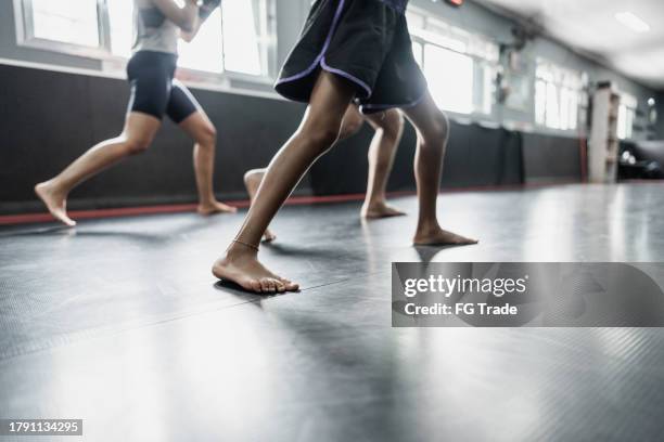 low section of people practicing muay thai or kickboxing at gym - beautiful girls legs stock pictures, royalty-free photos & images