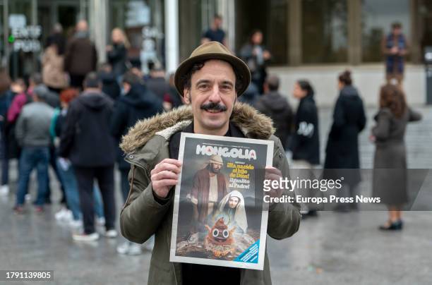 The editor of the satirical magazine Mongolia, Dario Adanti, poses with the cover of the magazine on the day they committed the alleged crime, at the...