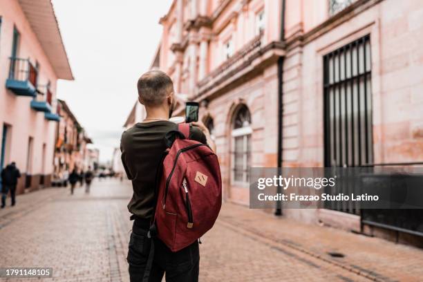 traveler young man filming historic district - colombia street stock pictures, royalty-free photos & images