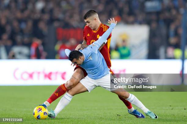 Gianluca Mancini of AS Roma and Pedro of SS Lazio battle for the ball during the Serie A TIM match between SS Lazio and AS Roma at Stadio Olimpico on...