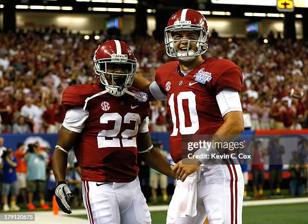 Christion Jones and AJ McCarron of the Alabama Crimson Tide celebrate Jones' touchdown reception against the Virginia Tech Hokies at Georgia Dome on...