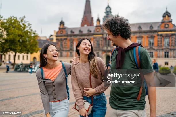 three young friends walking on the stortorget square in malmo in sweden - malmö bildbanksfoton och bilder