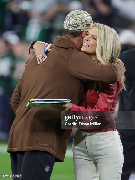 Quarterback Aaron Rodgers of the New York Jets hugs NBC Sunday Night Football sideline reporter Melissa Stark on the field before a game between the...