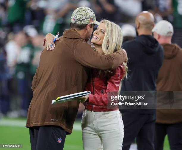 Quarterback Aaron Rodgers of the New York Jets hugs NBC Sunday Night Football sideline reporter Melissa Stark on the field before a game between the...