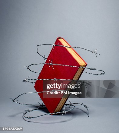 Banned book in barbed wire Banned book in barbed wire