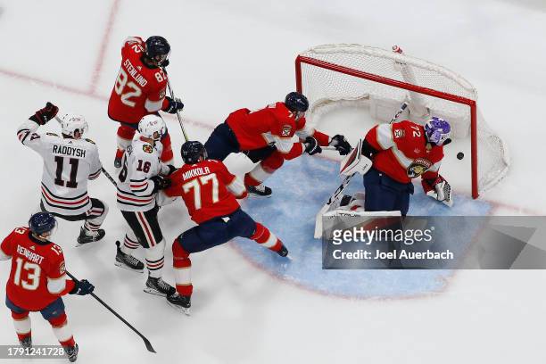 Jason Dickinson of the Chicago Blackhawks scores a first period goal past Goaltender Sergei Bobrovsky of the Florida Panthers at the Amerant Bank...