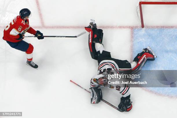 Goaltender Arvid Soderblom of the Chicago Blackhawks stops a shot by Anton Lundell of the Florida Panthers at the Amerant Bank Arena on November 12,...