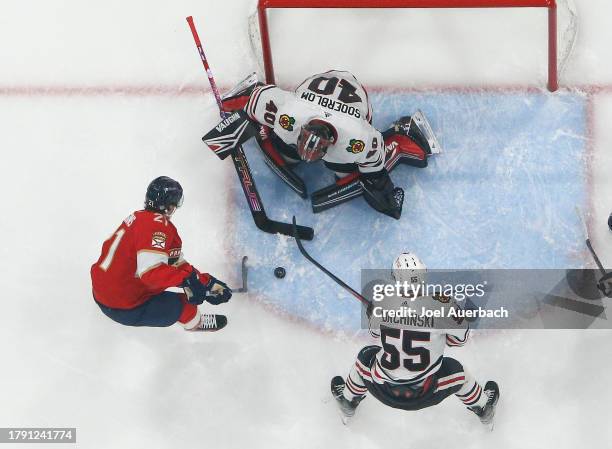 Goaltender Arvid Soderblom of the Chicago Blackhawks stops a shot by Nick Cousins of the Florida Panthers at the Amerant Bank Arena on November 12,...
