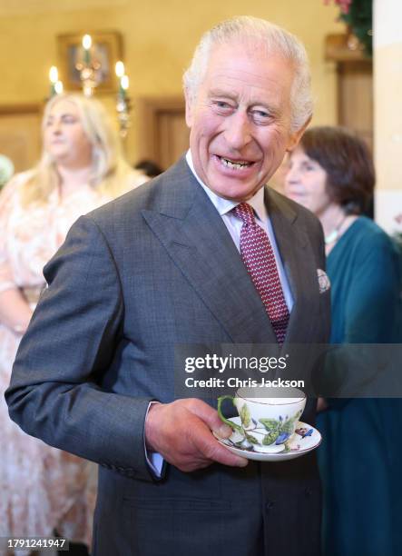 King Charles III's shares a joke with guests as he attends his 75th birthday party hosted by the Prince's Foundation at Highgrove House on November...