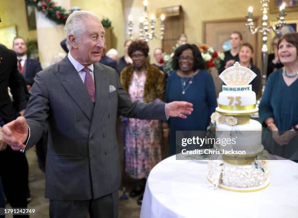 King Charles III poses with his cake as he attends his 75th birthday party hosted by the Prince's Foundation at Highgrove House on November 13, 2023...