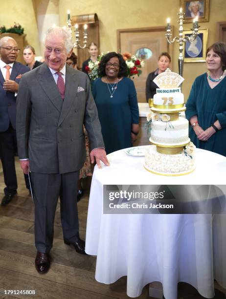 King Charles III poses with his cake as he attends his 75th birthday party hosted by the Prince's Foundation at Highgrove House on November 13, 2023...