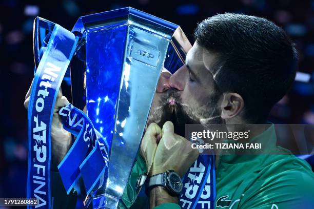 Serbia's Novak Djokovic kisses the trophy after winning the final match against Italy's Jannik Sinner at the ATP Finals tennis tournament in Turin on...