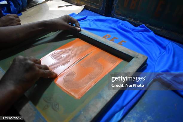 Person is printing a jersey of the Indian cricket team ahead of the ICC men's cricket final World Cup match between India and Australia in Kolkata,...