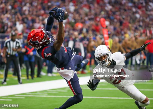 Houston Texans wide receiver Tank Dell completes a catch in the end zone and scores a touchdown in the second quarter during the NFL game between the...