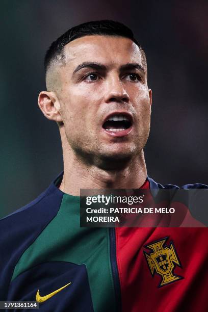 Portugal's forward Cristiano Ronaldo sings the national anthem prior to the UEFA Euro 2024 group J qualifying football match between Portugal and...