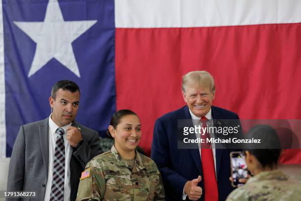 Former President Donald Trump poses for a photo with a service member at the South Texas International airport on November 19, 2023 in Edinburg,...