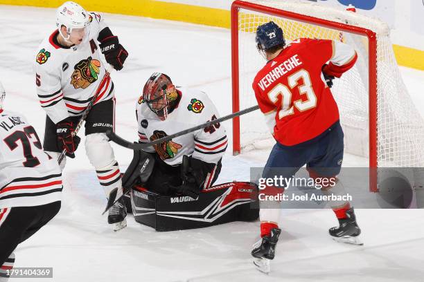 Goaltender Arvid Soderblom of the Chicago Blackhawks stops a shot by Carter Verhaeghe of the Florida Panthers at the Amerant Bank Arena on November...