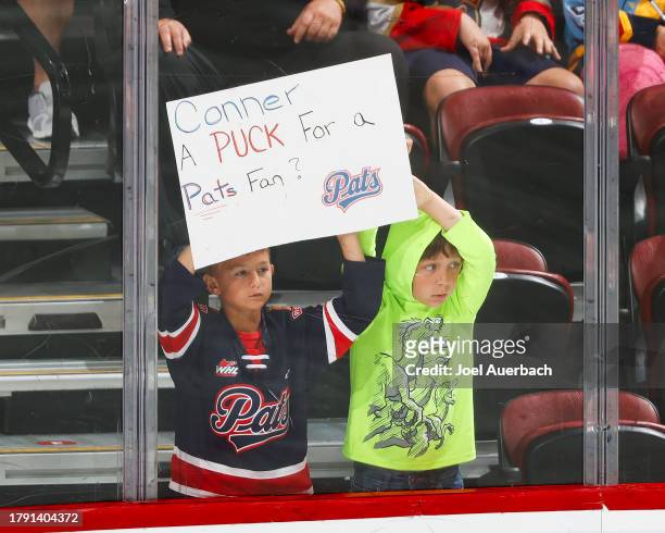 Two young fans hold a sign for Connor Bedard of the Chicago Blackhawks at the start of third period action against the Florida Panthers at the...