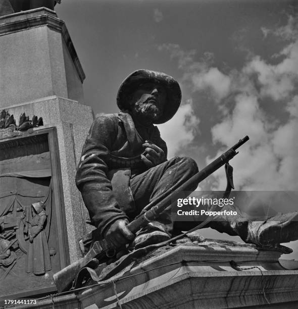 Close up view of a bronze figure of a Boer soldier seated at the base of the statue and monument to South African politician Paul Kruger located...