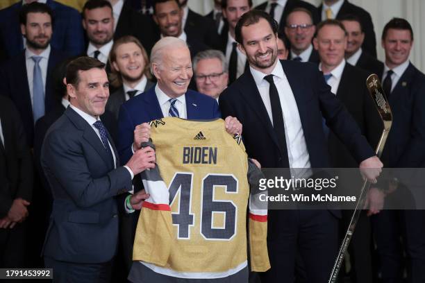 President Joe Biden holds up a hockey sweater presented by Las Vegas Golden Knights Mark Stone and President of Hockey Operations George McPhee...