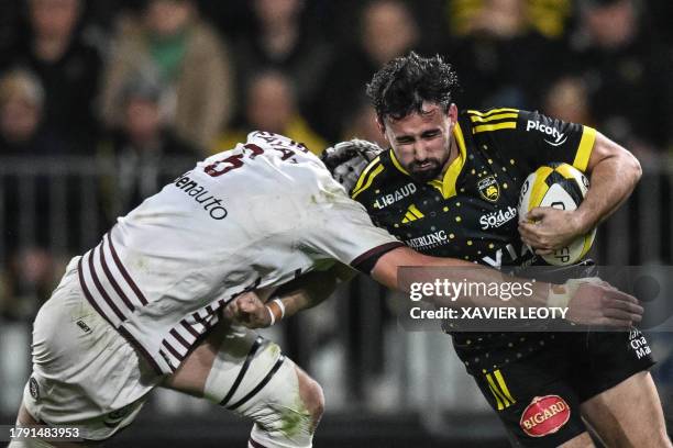 La Rochelle's French fly-half Antoine Hastoy is tackled by Bordeaux-Begles' French flanker Pierre Bochaton during the French Top14 rugby union match...