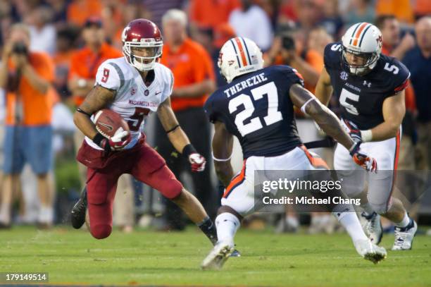 Wide receiver Gabe Marks of the Washington State Cougars looks to maneuver around defensive back Robenson Therezie of the Auburn Tigers during the...