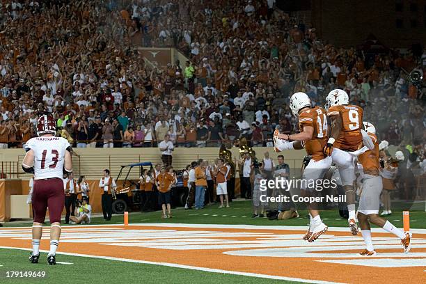 John Harris of the Texas Longhorns celebrates with quarterback David Ash after catching a 54 yard touchdown pass against the New Mexico State Aggies...