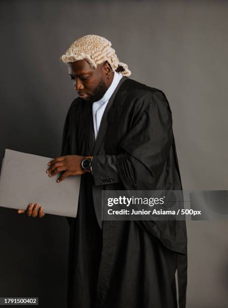 portrait of young black man with old whitehead wig on head and judges wardrobe,accra,ghana - judges robe stock pictures, royalty-free photos & images