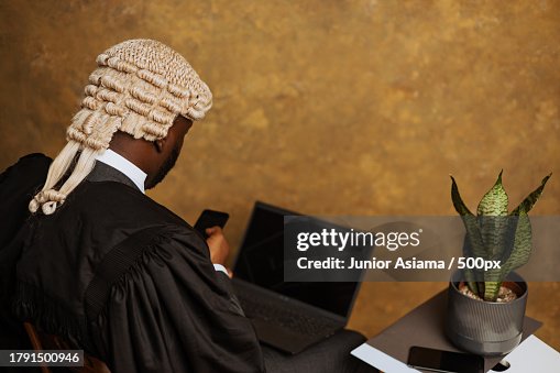 Portrait of young black Man with old whitehead wig on head and judges wardrobe,Accra,Ghana Portrait of young black Man with old whitehead wig on head and judges wardrobe,Accra,Ghana