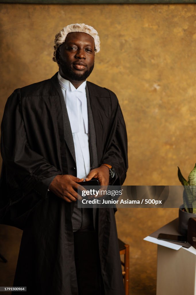 Portrait of young black Man with old whitehead wig on head and judges wardrobe,Accra,Ghana