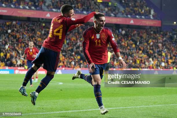 Spain's midfielder Ferran Torres celebrates scoring his team's second goal, with Spain's defender Jose Luis Gaya Pena, during the UEFA Euro 2024...