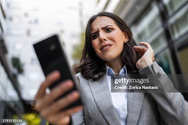 stressed businesswoman venting frustration - cell phone confused stock pictures, royalty-free photos & images