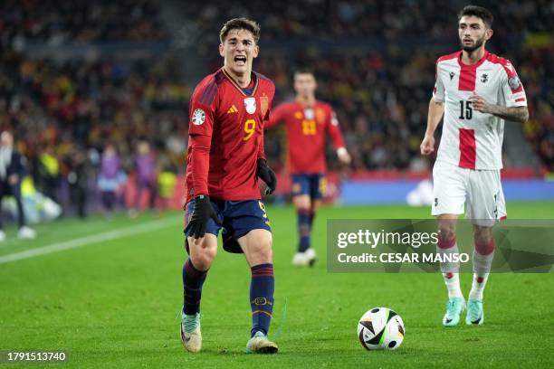 Spain's midfielder Gavi reacts to injuring his knee during the UEFA Euro 2024 group A qualifying football match between Spain and Georgia at the Jose...