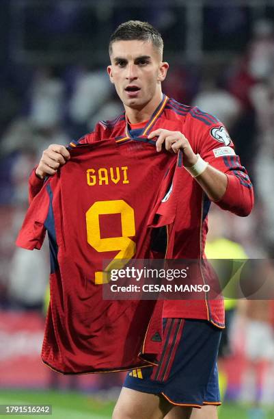 Spain's midfielder Ferran Torres holds the jersey of teammate Spain's midfielder Gavi as he celebrates scoring his team's second goal during the UEFA...