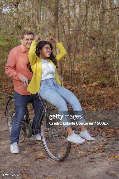 portrait of cute young couple walking in autumn forest,munich,germany - peel park stock pictures, royalty-free photos & images