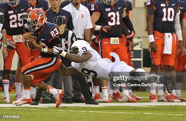 Penn State's Jordan Lucas tackles Syracuse's Prince-Tyson Gulley in the second half at MetLife Stadium in East Rutherford, New Jersey, on Saturday,...