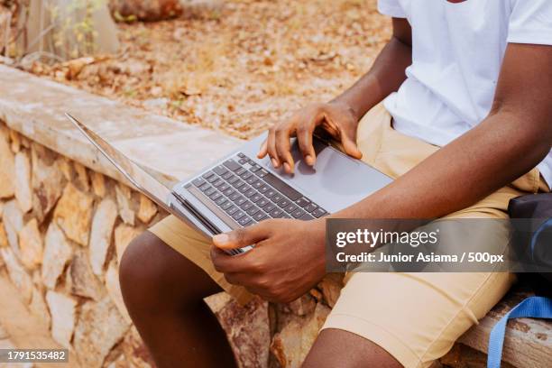 portrait of black student on campus learning with laptop and mobile phone technology,tema,ghana - ghana phone stock pictures, royalty-free photos & images