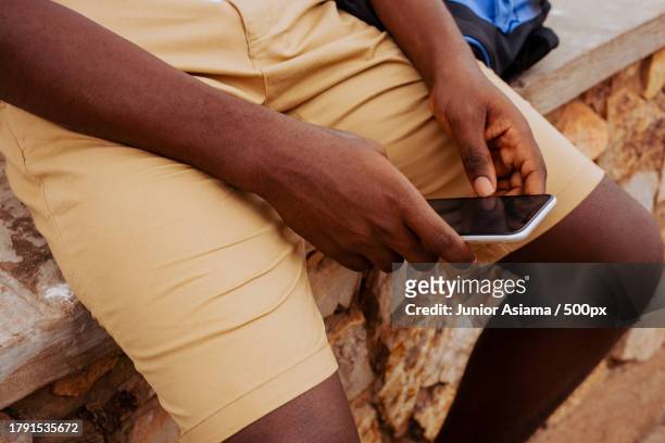portrait of black student on campus learning with mobile phone technology,tema,ghana - ghana phone stock pictures, royalty-free photos & images