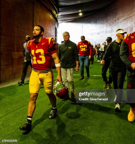 Trojans quarterback Caleb Williams walks through the tunnel to the field with head coach Lincoln Riley on the right before the game against UCLA at...