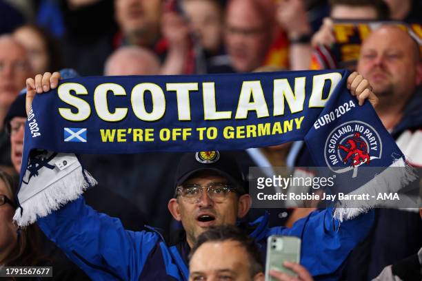 Fan of Scotland holds up a scarf reading 'we're off the Germany' during the UEFA EURO 2024 European qualifier match between Scotland and Norway at on...