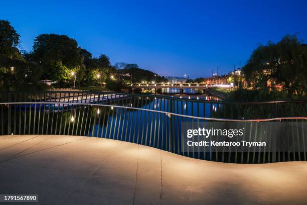 a bridge over a canal in a big city, in twilight light. - malmo stock pictures, royalty-free photos & images