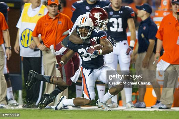 Safety Deone Bucannon of the Washington State Cougars tackles running back Corey Grant of the Auburn Tigers during the second half of play on August...