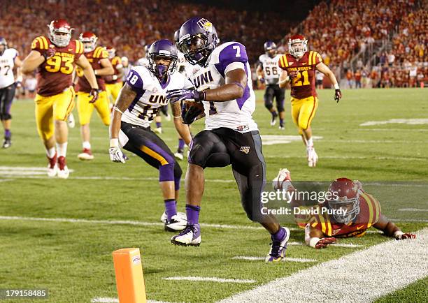 Running back David Johnson of the Northern Iowa Panthers rushes past defensive end Willie Scott of the Iowa State Cyclones to score a touchdown in...